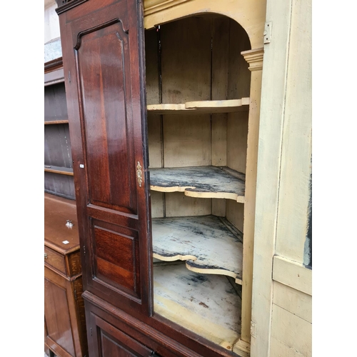 497 - A George III oak flat front corner cabinet with two upper doors, three internal shelves, two lower d... 