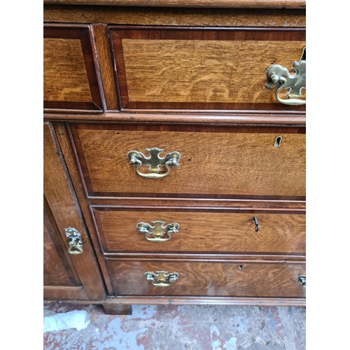 498 - A George III oak welsh dresser with upper plate rack, three upper drawers, two cupboard doors and th... 