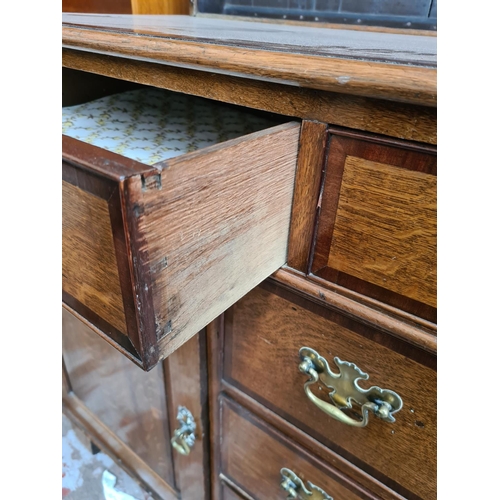 498 - A George III oak welsh dresser with upper plate rack, three upper drawers, two cupboard doors and th... 