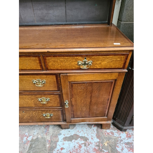 498 - A George III oak welsh dresser with upper plate rack, three upper drawers, two cupboard doors and th... 