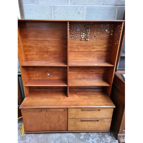 499 - A mid 20th century Meredew teak wall unit - measuring approx. 134cm wide, 166cm high with top, 56cm ... 