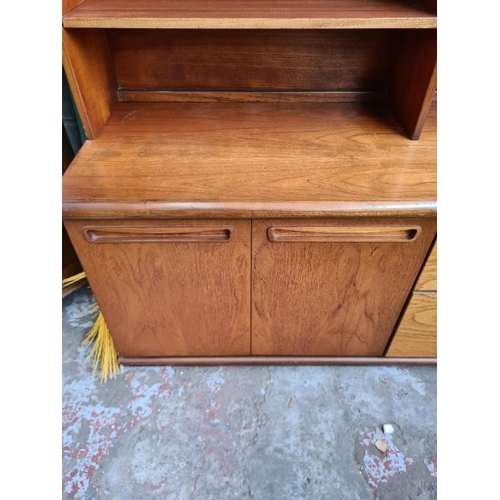 499 - A mid 20th century Meredew teak wall unit - measuring approx. 134cm wide, 166cm high with top, 56cm ... 