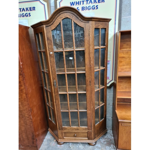 500 - An oak flat front display cabinet with one door, one drawer and key - measuring approx. 192cm high a... 