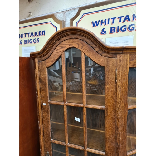 500 - An oak flat front display cabinet with one door, one drawer and key - measuring approx. 192cm high a... 