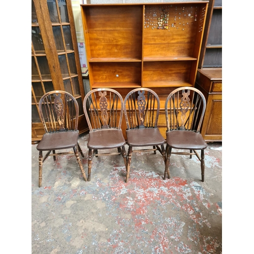 503 - Four oak wheel back dining chairs with brown leatherette upholstery