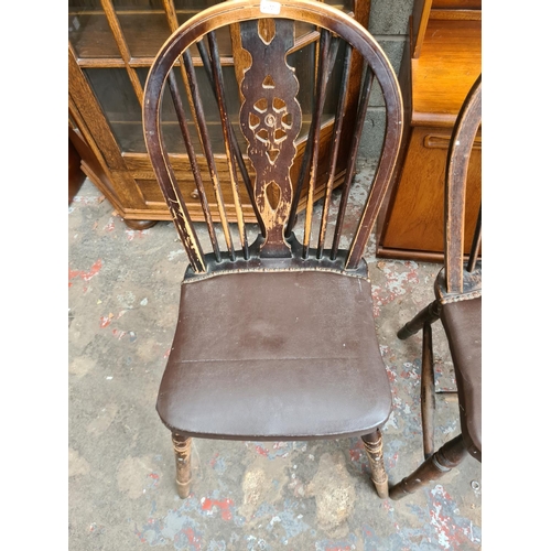 503 - Four oak wheel back dining chairs with brown leatherette upholstery