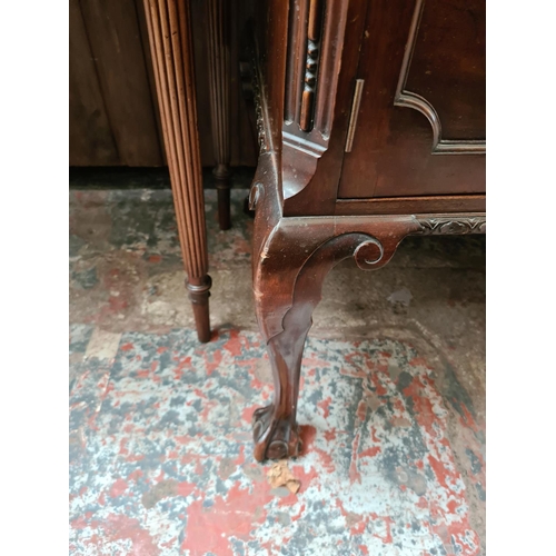 505 - A mahogany two door cabinet on ball and claw supports - measuring approx. 78cm high, 121cm wide and ... 