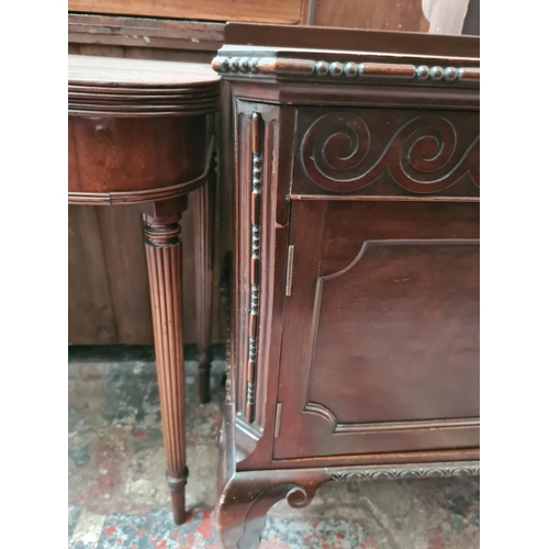 505 - A mahogany two door cabinet on ball and claw supports - measuring approx. 78cm high, 121cm wide and ... 