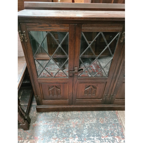 509 - A Jaycee oak bookcase with four doors - measuring approx. 88cm high, 140cm wide and 29cm deep