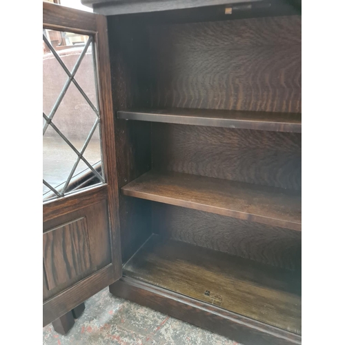 509 - A Jaycee oak bookcase with four doors - measuring approx. 88cm high, 140cm wide and 29cm deep