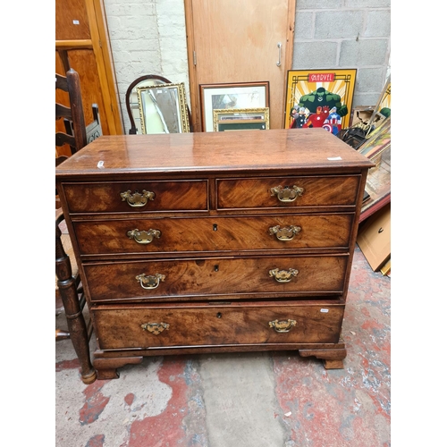 517 - A George III mahogany chest of two short over three long drawers on ogee bracket supports - measurin... 