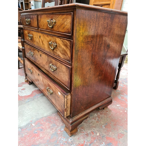 517 - A George III mahogany chest of two short over three long drawers on ogee bracket supports - measurin... 