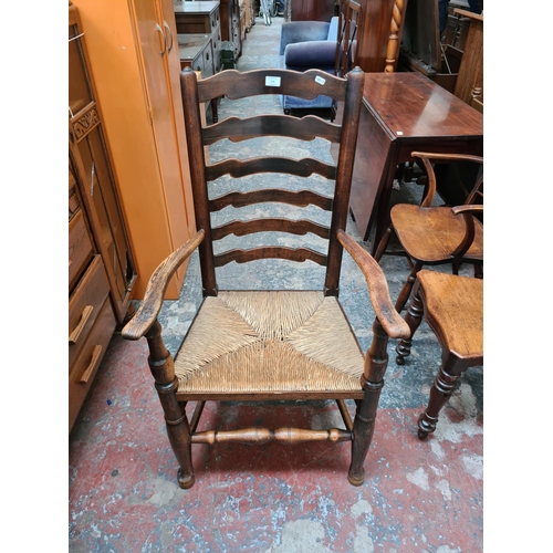 518 - A 19th century elm farmhouse ladder back armchair with rush seat and lower stretcher - measuring app... 