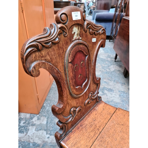 519 - A 19th century oak shieldback hall chair