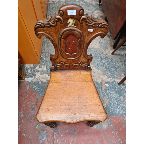 519 - A 19th century oak shieldback hall chair