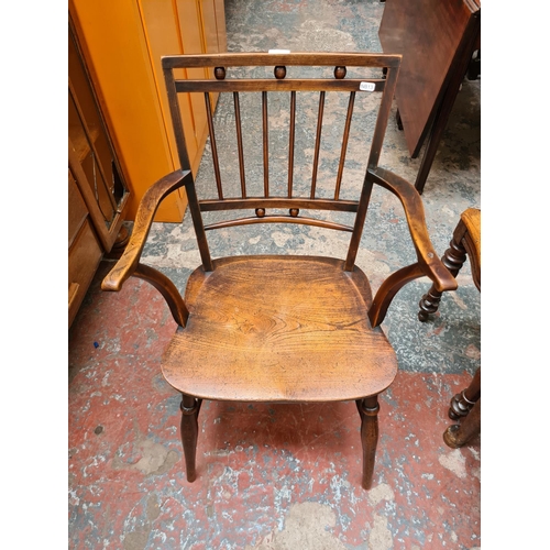 520 - An Arts and Crafts elm elbow chair - measuring approx. 83.5cm high, 52cm wide and 43cm height to sea... 