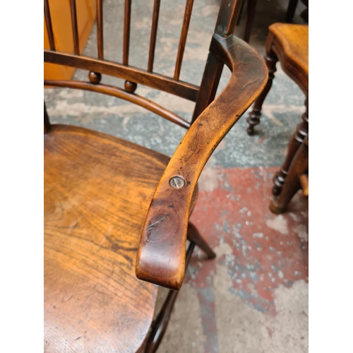 520 - An Arts and Crafts elm elbow chair - measuring approx. 83.5cm high, 52cm wide and 43cm height to sea... 