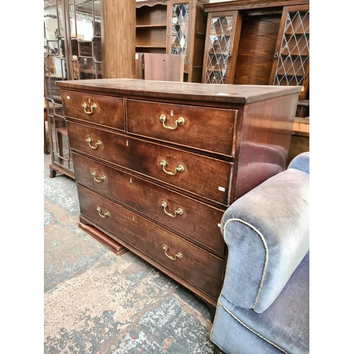 525 - A George III mahogany chest of two short over three long drawers with brass swan neck handles and br... 