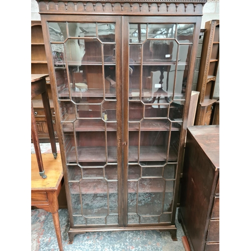 526 - An early 20th century mahogany display cabinet with two glazed doors - measuring approx. 189cm high,... 