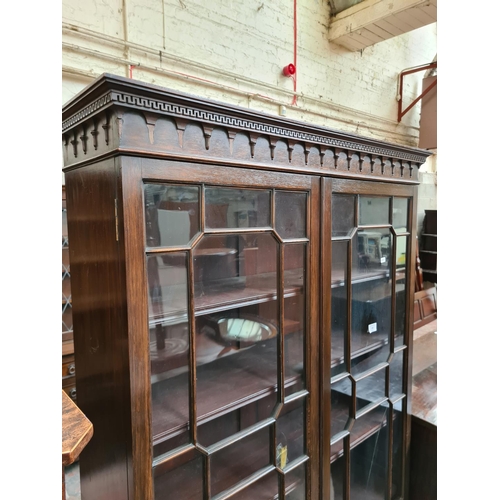 526 - An early 20th century mahogany display cabinet with two glazed doors - measuring approx. 189cm high,... 