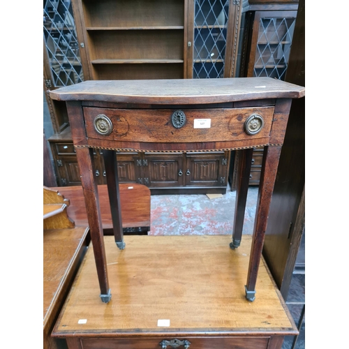 527 - A Regency mahogany side table with serpentine top, satinwood and ebony inlay and later added handles... 