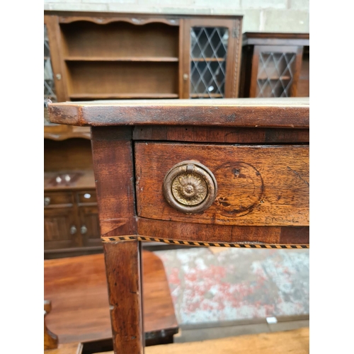 527 - A Regency mahogany side table with serpentine top, satinwood and ebony inlay and later added handles... 