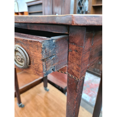 527 - A Regency mahogany side table with serpentine top, satinwood and ebony inlay and later added handles... 