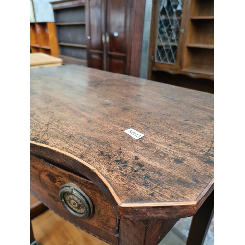 527 - A Regency mahogany side table with serpentine top, satinwood and ebony inlay and later added handles... 