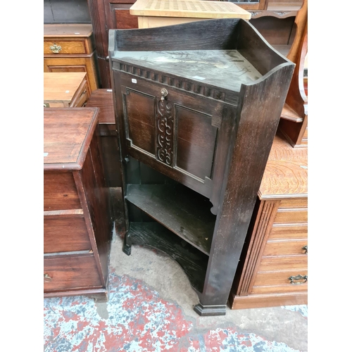 530 - An early 20th century oak freestanding corner bureau cabinet with fall front, internal storage and t... 