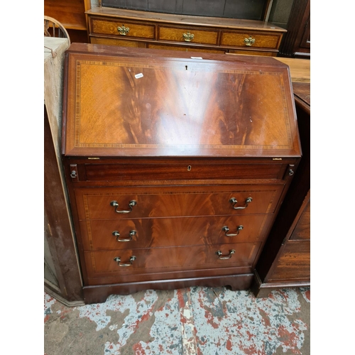 532 - A Georgian style inlaid mahogany effect bureau with fall front and three lower drawers and a mahogan... 