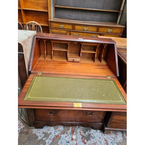 532 - A Georgian style inlaid mahogany effect bureau with fall front and three lower drawers and a mahogan... 