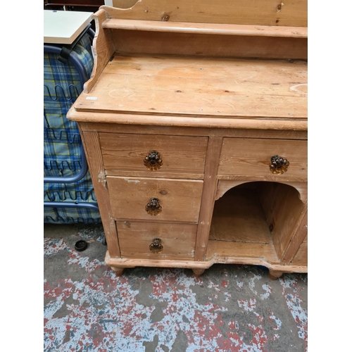 534 - A Victorian pine dog kennel sideboard with six outer drawers and one central drawer - 101cm high, 10... 