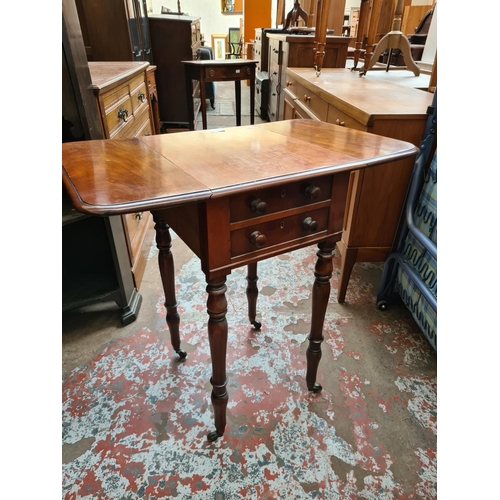 537 - A 19th century mahogany drop leaf work table with two drawers and two frieze drawers on brass castor... 