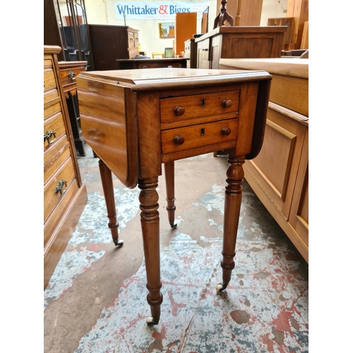 538 - A 19th century mahogany drop leaf work table with two drawers and two frieze drawers on ceramic cast... 