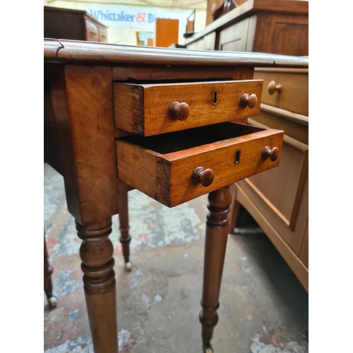 538 - A 19th century mahogany drop leaf work table with two drawers and two frieze drawers on ceramic cast... 