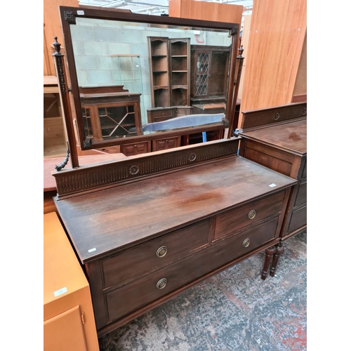 544 - An Edwardian carved mahogany two piece bedroom suite on reeded supports comprising dressing table wi... 