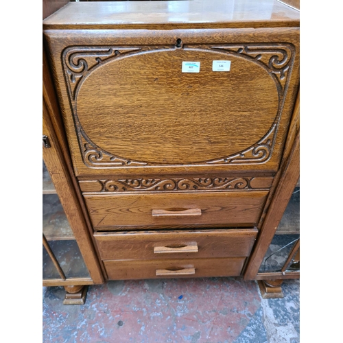 546 - An Art Deco oak side by side bureau bookcase with three central drawers, fall front and two glazed d... 