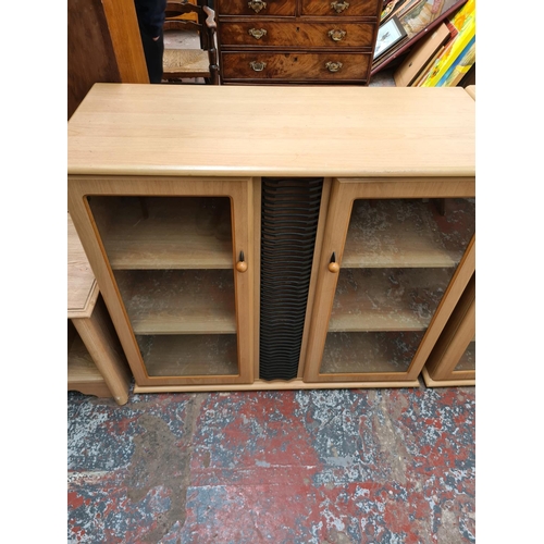 548 - Three items to include a modern oak effect two door media cabinet with central CD rack, a matching s... 