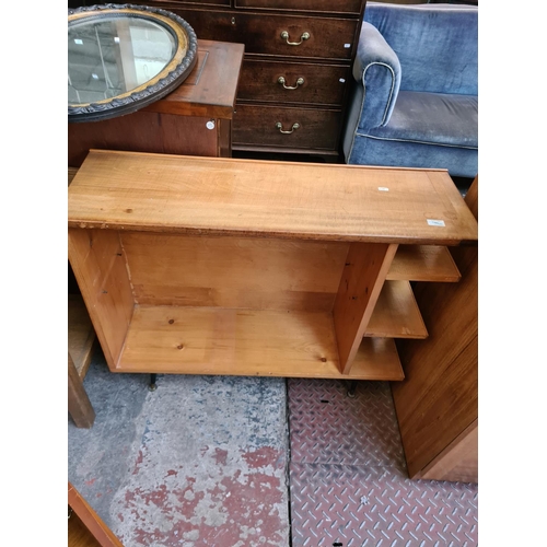 553 - Two items to include a yew wood bookcase with two drawers and a pine shelving unit (see condition re... 