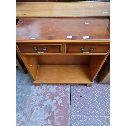 553 - Two items to include a yew wood bookcase with two drawers and a pine shelving unit (see condition re... 