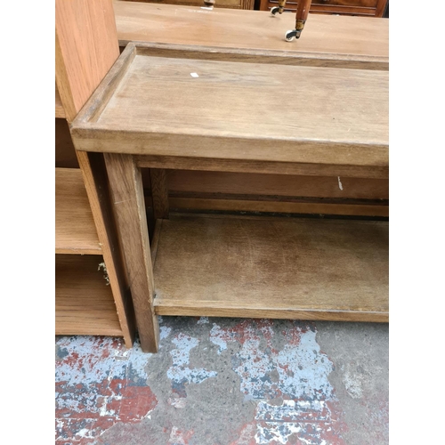 555 - An oak two tier console table - measuring approx. measuring approx. 125cm wide and 71cm high