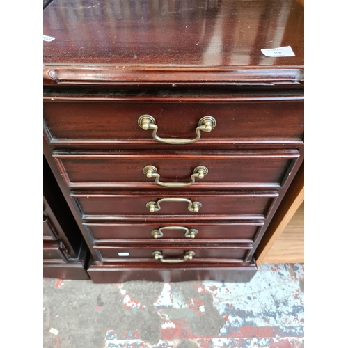 558 - A pair of mahogany five drawer bedside cabinets - measuring approx. 57cm high, 48cm wide and 35cm de... 