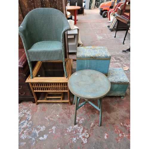 560 - Five items to include a Lloyd Loom style green painted wicker tub chair, cane coffee table with glas... 