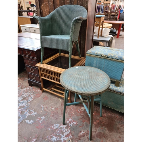 560 - Five items to include a Lloyd Loom style green painted wicker tub chair, cane coffee table with glas... 