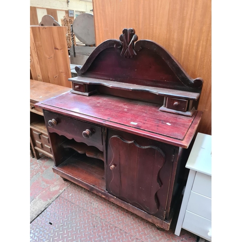 566 - A stained pine sideboard with one cupboard door, one long drawer and two further short drawers