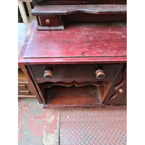 566 - A stained pine sideboard with one cupboard door, one long drawer and two further short drawers