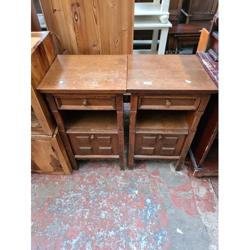 567 - A pair of oak bedside cabinets - measuring approx. 76cm high, 44cm wide and 38cm deep