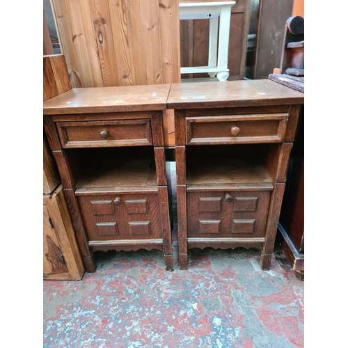 567 - A pair of oak bedside cabinets - measuring approx. 76cm high, 44cm wide and 38cm deep