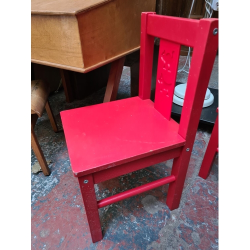 572 - A mid 20th century plywood child's school desk and chair together with a pair of Ikea Kritter red ch... 