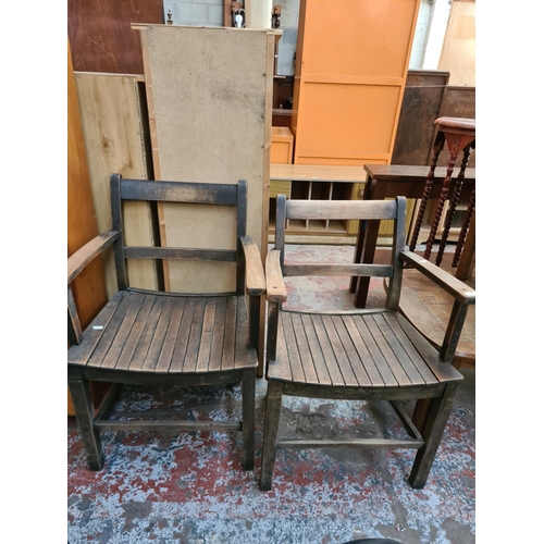 574 - A pair of vintage oak carver dining chairs with slatted seats.